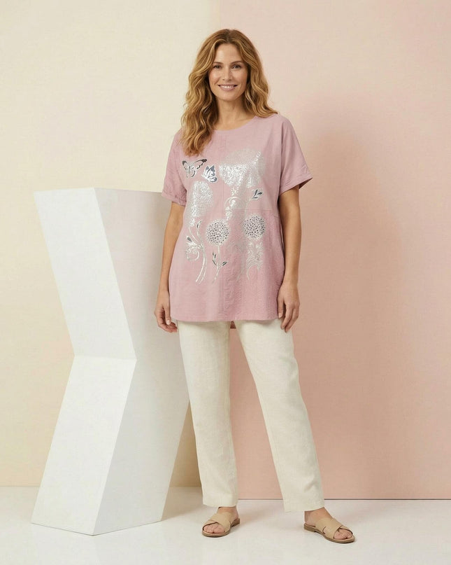 Лятна памучна туника в нежно розово със сребрист флорален принт и къс ръкав, показана върху модел в кадър в цял ръст.