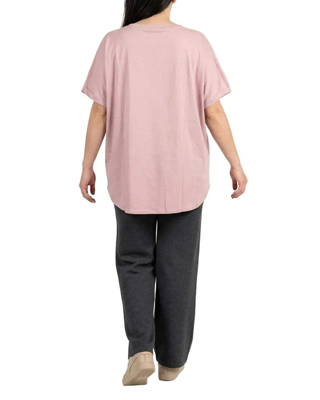 Изглед отзад на лятна памучна туника в нежно розово, показващ късите ръкави и свободно падащия извит подгъв на бял фон.