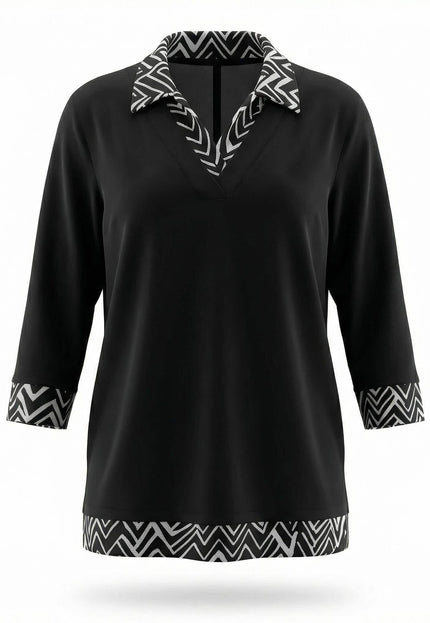 Официална черна туника големи размери с яка, маншети и подгъв в черно-бял зигзаг десен, заснета отпред на бял фон