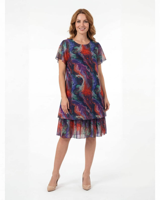 Официална разкроена рокля големи размери от пъстър шифон с къси ръкави, снимана в цял ръст на бял фон.