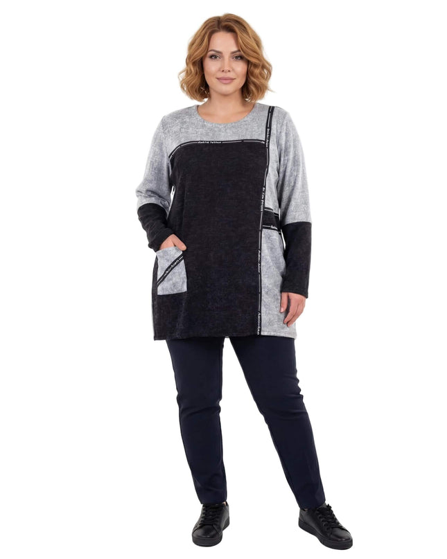 Дамска сива туника в големи размери с черен преден панел и страничен джоб с декоративна лента. Снимка на модел в цял ръст на бял фон.